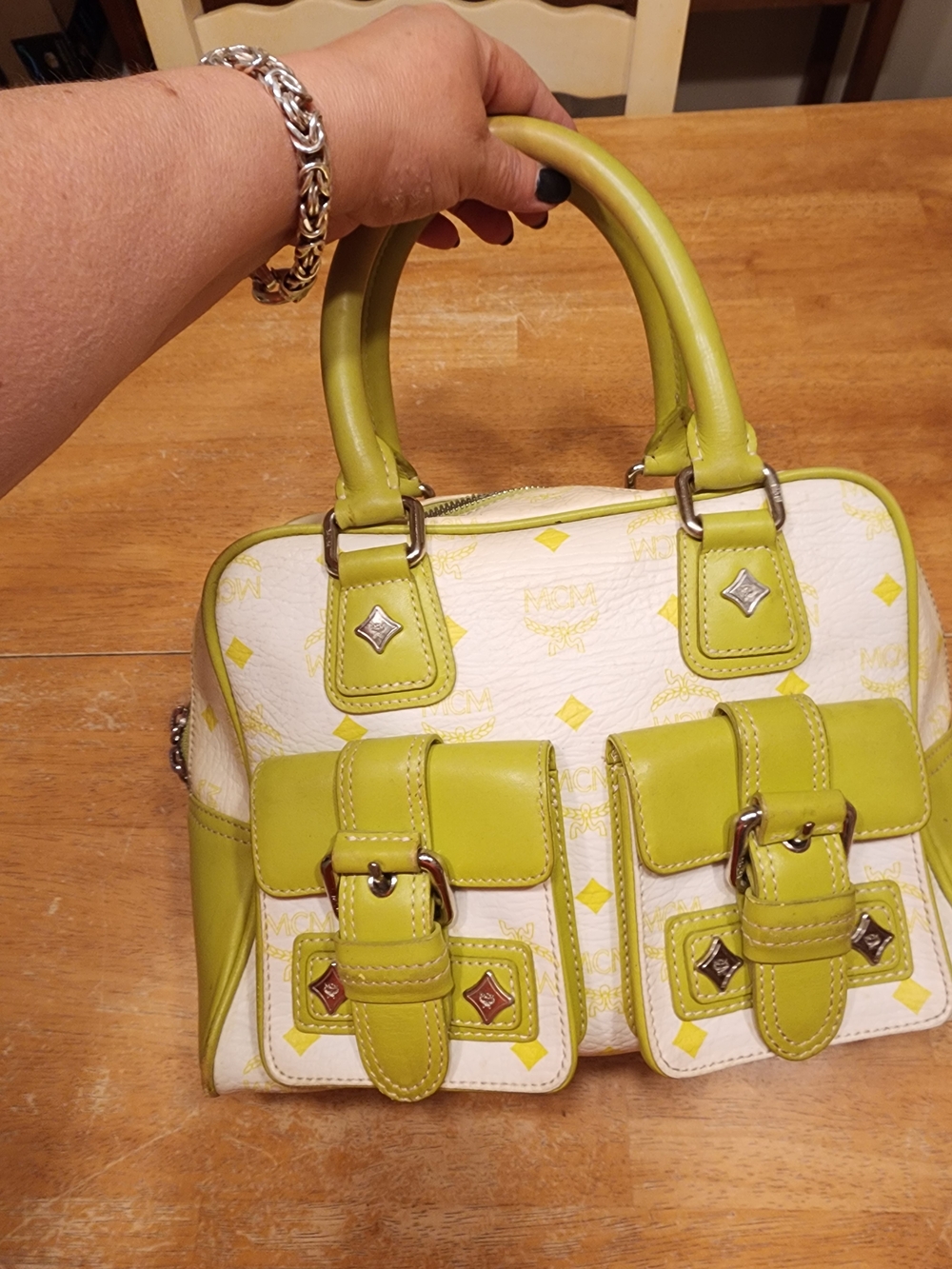 top handle satchel stands out immediately  distinctive double front buckled